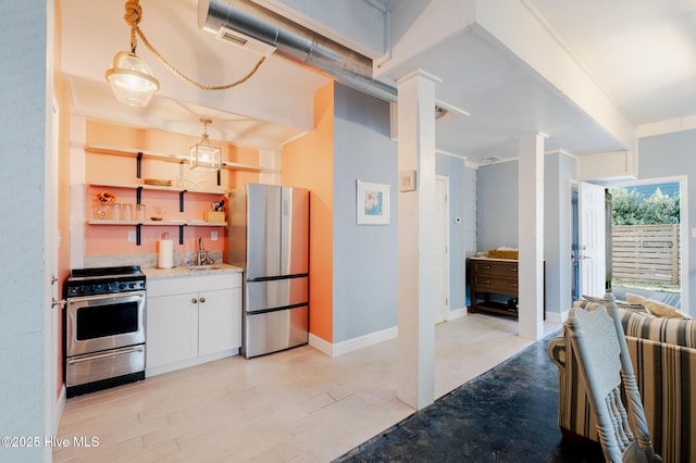 kitchen featuring white cabinets, appliances with stainless steel finishes, light hardwood / wood-style flooring, and sink