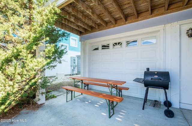 view of patio / terrace featuring a garage