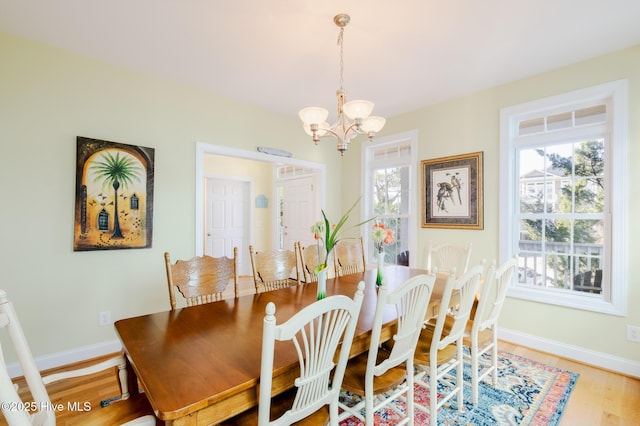 dining space featuring a chandelier and hardwood / wood-style floors