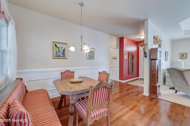 dining room featuring light hardwood / wood-style flooring and an inviting chandelier