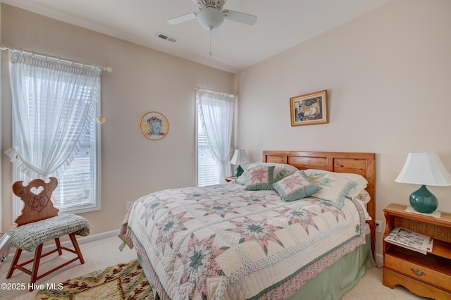 bedroom featuring carpet flooring, ceiling fan, and multiple windows