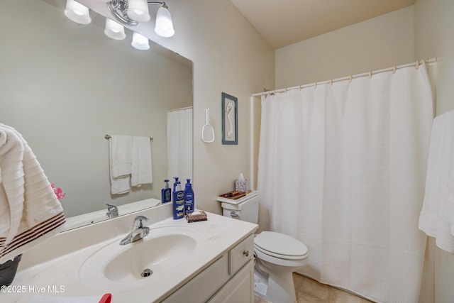 bathroom featuring tile patterned flooring, vanity, and toilet