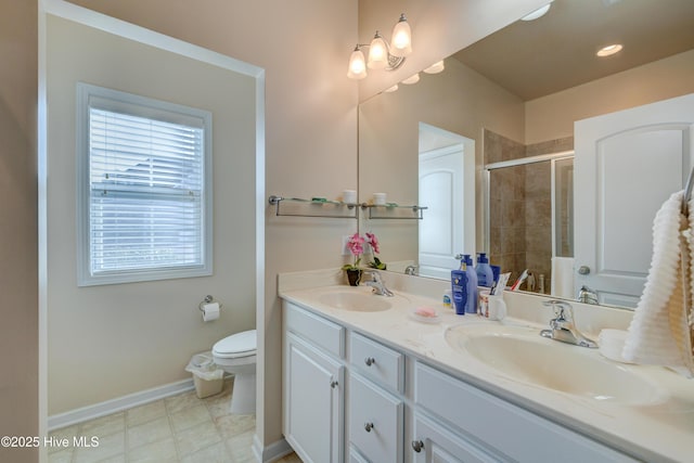 bathroom featuring vanity, toilet, and walk in shower