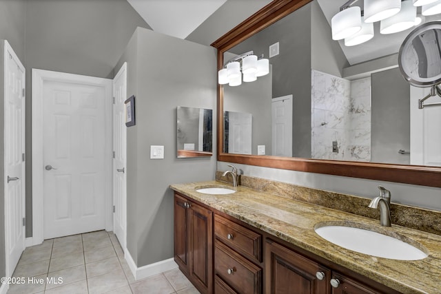 bathroom featuring tile patterned flooring, vanity, and vaulted ceiling