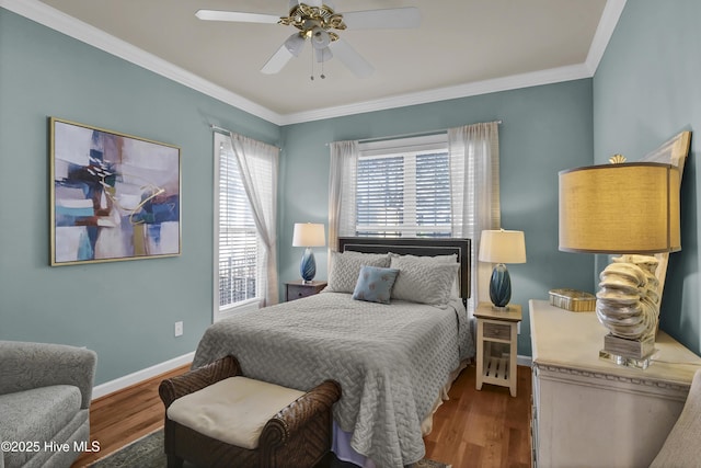 bedroom with hardwood / wood-style floors, ceiling fan, and ornamental molding