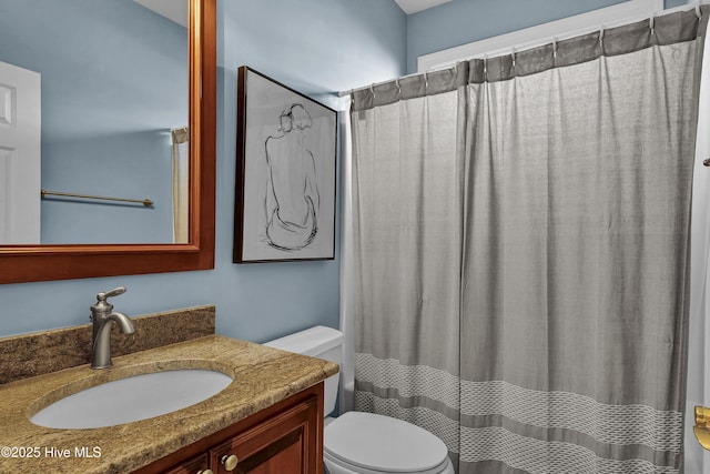 bathroom with a shower with shower curtain, vanity, and toilet