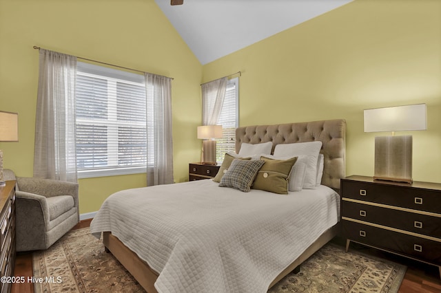 bedroom with dark hardwood / wood-style floors and lofted ceiling