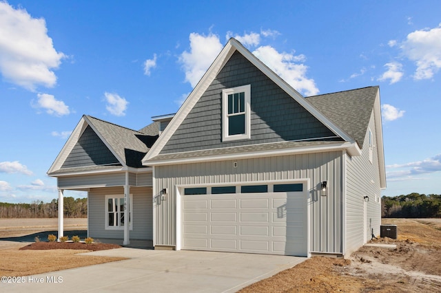 view of front of house featuring a garage and central AC