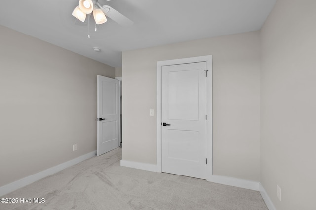 unfurnished bedroom with ceiling fan and light colored carpet