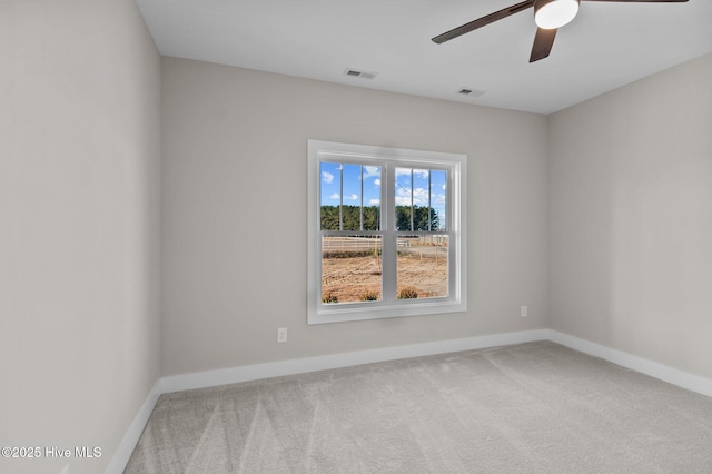 carpeted spare room with ceiling fan