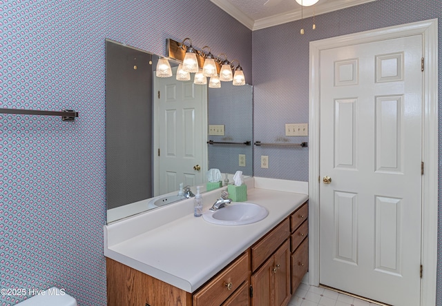 bathroom featuring crown molding, ceiling fan, and vanity