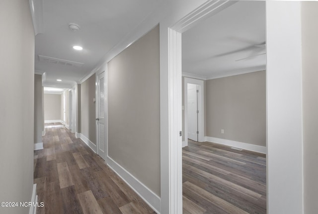 hallway with crown molding and dark hardwood / wood-style flooring