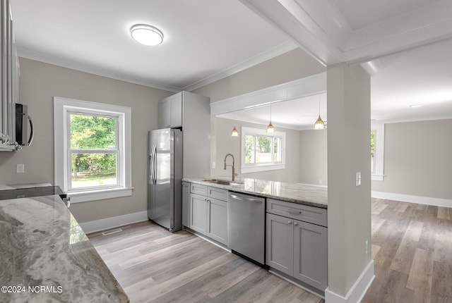 kitchen featuring light wood-type flooring, light stone counters, gray cabinetry, stainless steel appliances, and sink