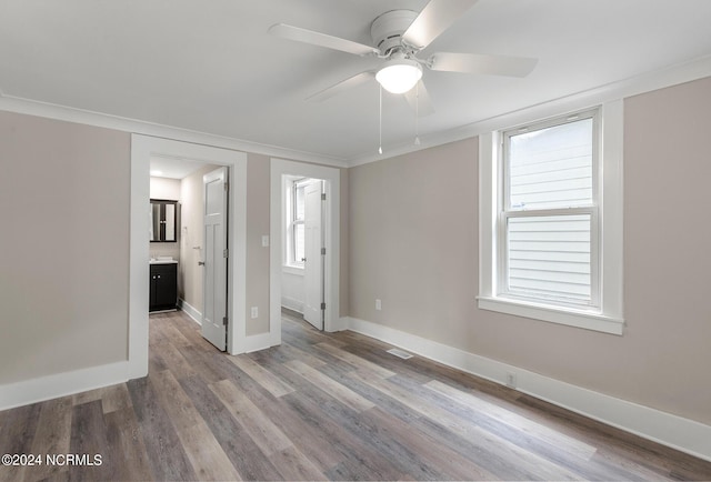 unfurnished room featuring ceiling fan, ornamental molding, and light hardwood / wood-style flooring