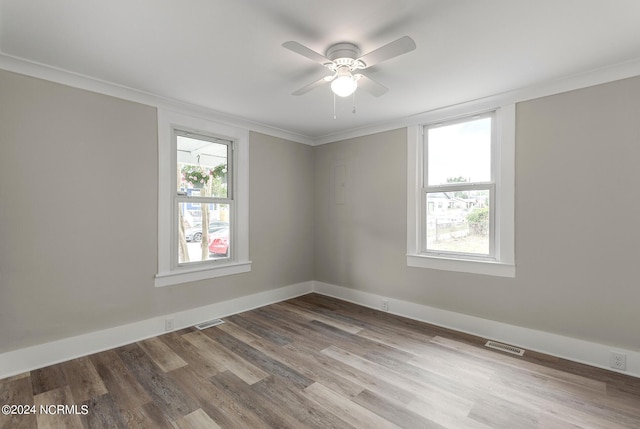 unfurnished room with hardwood / wood-style flooring, ceiling fan, and crown molding