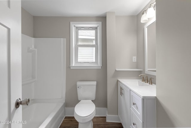 full bathroom featuring hardwood / wood-style floors, vanity, toilet, and shower / tub combination