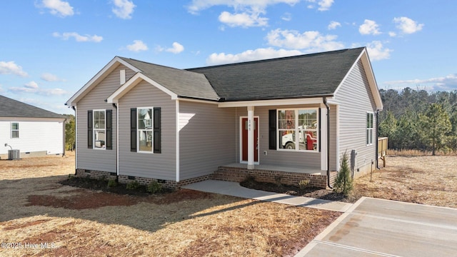 view of front of property featuring crawl space, central AC, and roof with shingles