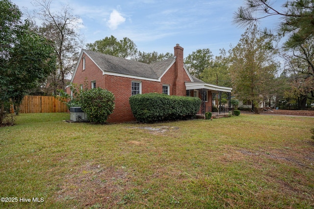 view of property exterior featuring central air condition unit, brick siding, fence, a lawn, and a chimney