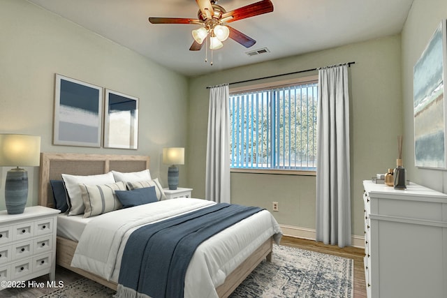 bedroom with hardwood / wood-style floors and ceiling fan