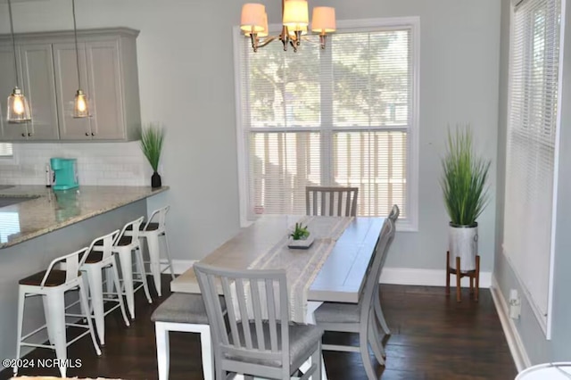 dining space with a chandelier and dark wood-type flooring