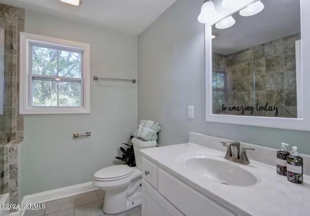 bathroom with tile patterned floors, a shower, vanity, and toilet