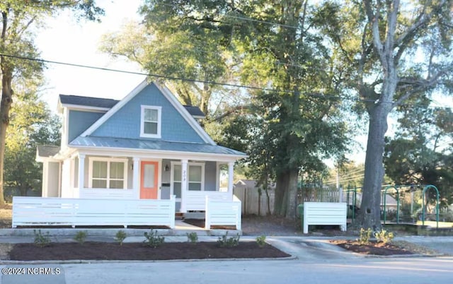 view of front of home with covered porch and a trampoline