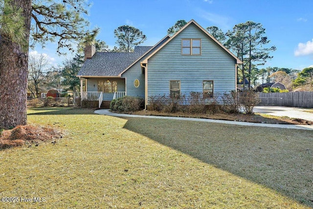 view of front of house with a porch and a front yard