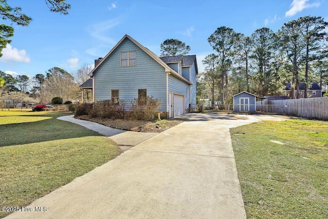 view of side of home featuring a garage and a lawn