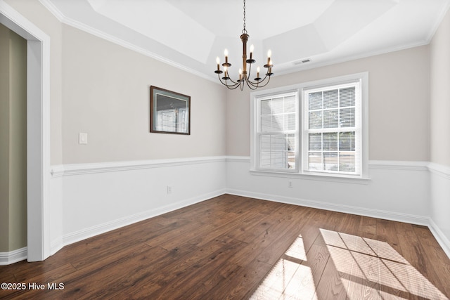 4379 Gauntlet Dr, Southport, NC 28461 - spare room featuring dark wood-style floors, a chandelier, a raised ceiling, baseboards, and ornamental molding