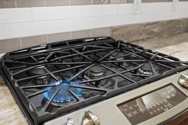 4379 Gauntlet Dr, Southport, NC 28461 - kitchen view of stainless steel gas stove and backsplash