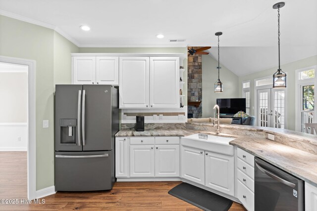 4379 Gauntlet Dr, Southport, NC 28461 - kitchen with stainless steel appliances, a sink, french doors, white cabinets, and pendant lighting
