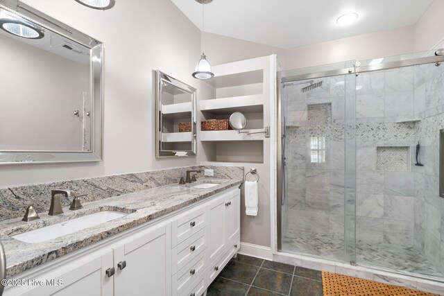 bedroom with a raised ceiling, ensuite bathroom, ceiling fan, and light carpet