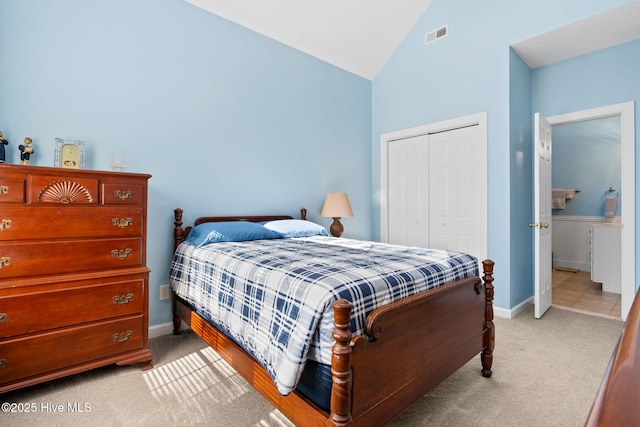 4379 Gauntlet Dr, Southport, NC 28461 - bedroom with light colored carpet, a closet, baseboards, and high vaulted ceiling