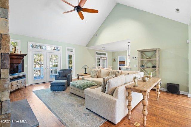 4379 Gauntlet Dr, Southport, NC 28461 - living area featuring french doors, high vaulted ceiling, a ceiling fan, hardwood / wood-style flooring, and baseboards