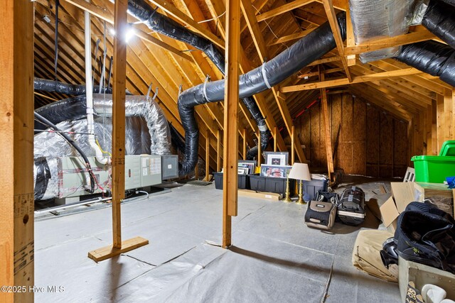 exercise room featuring ceiling fan, hardwood / wood-style floors, and vaulted ceiling with skylight