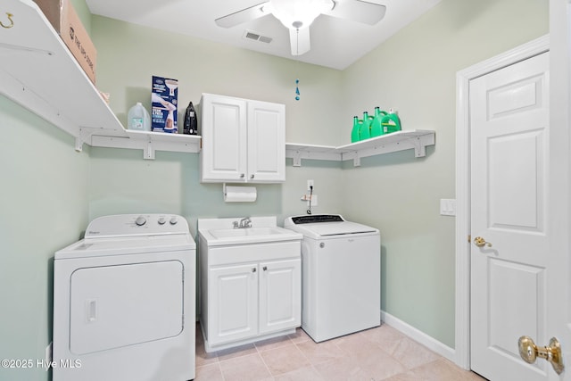 4379 Gauntlet Dr, Southport, NC 28461 - laundry room with separate washer and dryer, cabinet space, a ceiling fan, light tile patterned floors, and baseboards