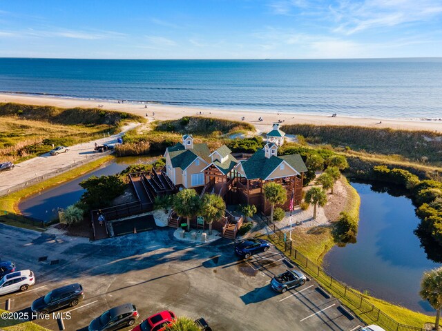 birds eye view of property with a water view and a view of the beach