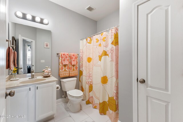 bathroom with vanity, tile patterned floors, and toilet