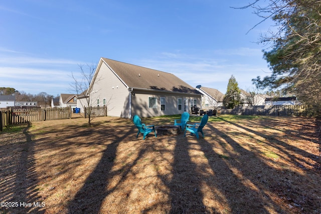 back of house featuring an outdoor fire pit