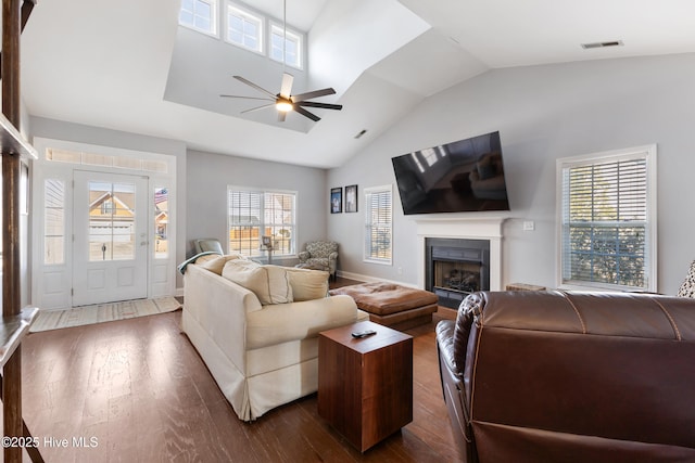 living room featuring ceiling fan, lofted ceiling, and dark hardwood / wood-style flooring