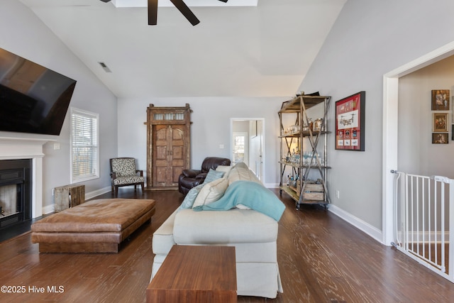 living room with lofted ceiling, dark hardwood / wood-style floors, and ceiling fan