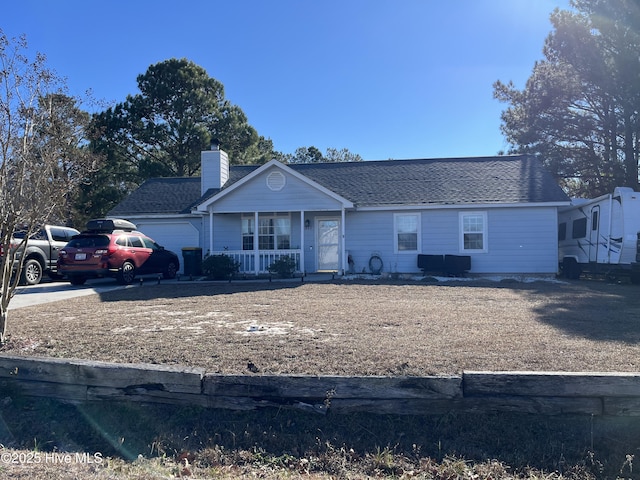 single story home with a porch and a garage