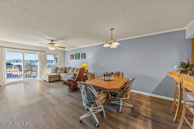 dining room featuring crown molding, dark hardwood / wood-style flooring, and a textured ceiling