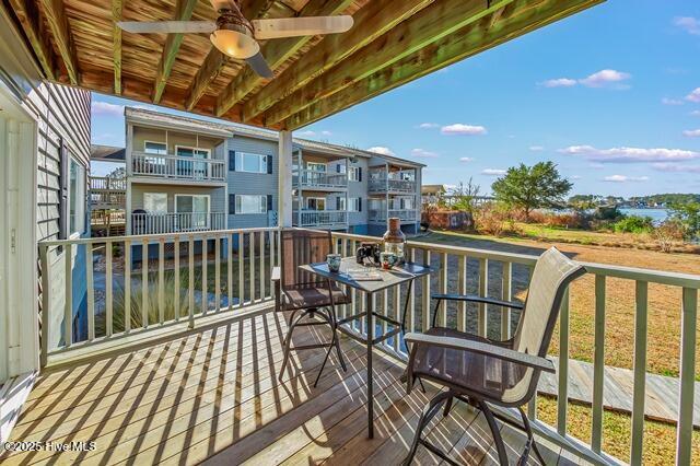 wooden balcony with a wooden deck and ceiling fan