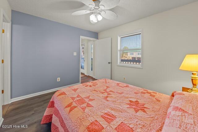 bedroom with ceiling fan and dark wood-type flooring