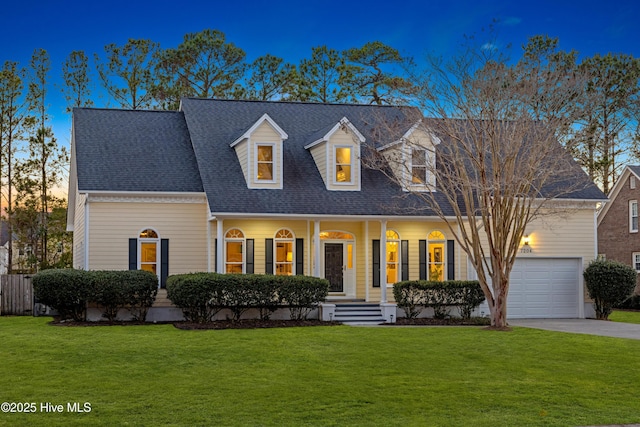 cape cod-style house featuring driveway, roof with shingles, a garage, and a front yard