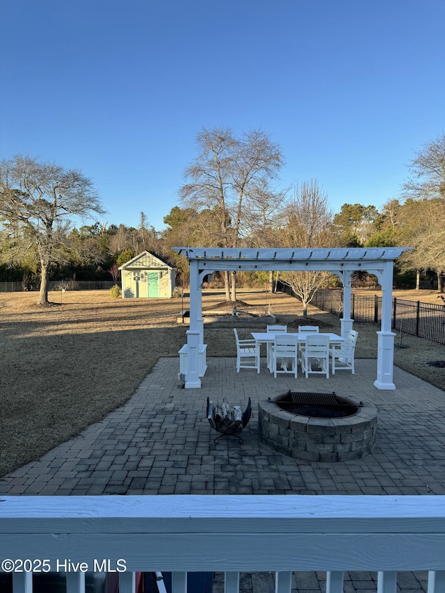 view of patio / terrace with an outdoor fire pit and a pergola