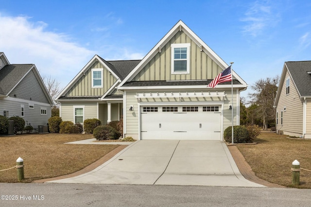 craftsman inspired home featuring central AC unit, board and batten siding, concrete driveway, and a shingled roof