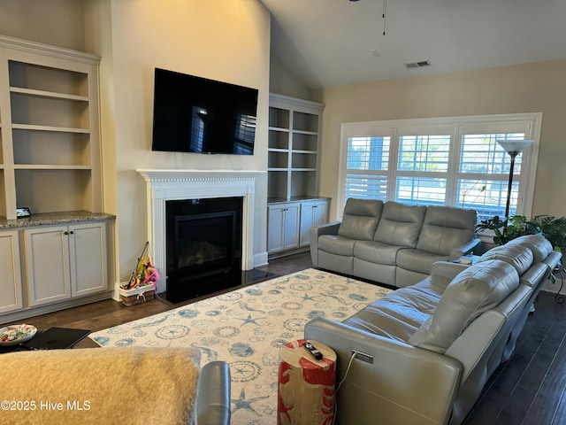 living room with lofted ceiling and dark hardwood / wood-style flooring