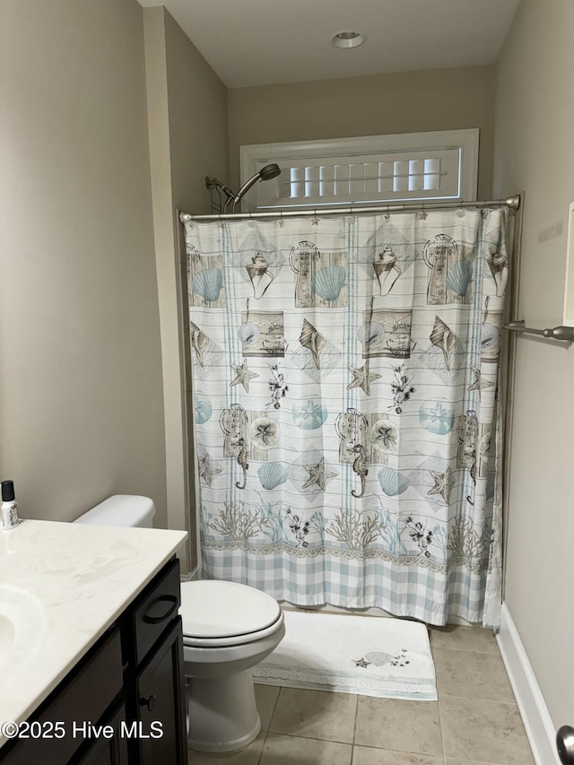 bathroom featuring toilet, vanity, tile patterned flooring, and a shower with shower curtain